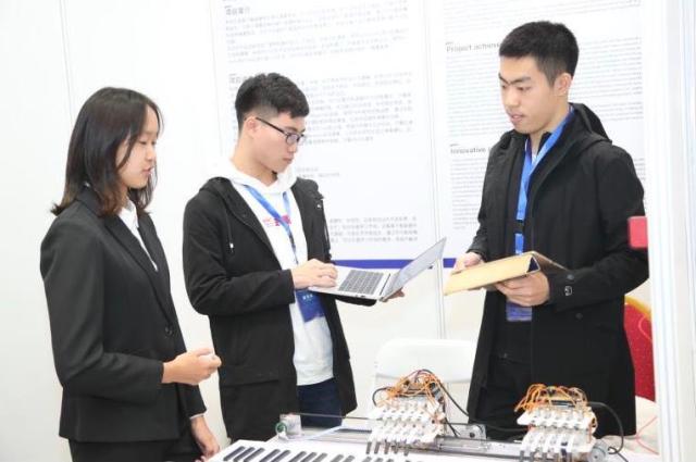 北航beat365中国唯一官网学生韩腾飞,带来其团队研发的会弹钢琴的机械手。(中关村管委会供图)